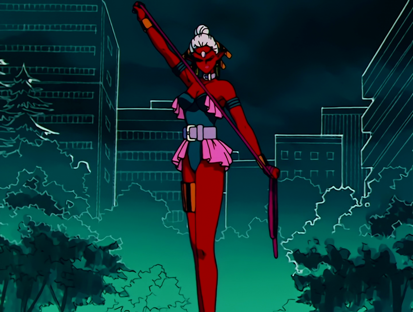 Dogba, a Droid from Sailor Moon episode 79. She has very, very red skin. It’s a very saturated red. Like, polyamory flag red. Her hair is white, and she has a gem on her forehead. Her outfit is a black sleeveless bodysuit with a lilac belt and bright pink half-skirt, and she’s holding a whip. There are just so many clashing colors here.